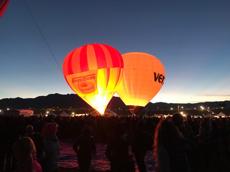 The Krispy Kreme and Verizon balloons seemed to be battling as they inflated