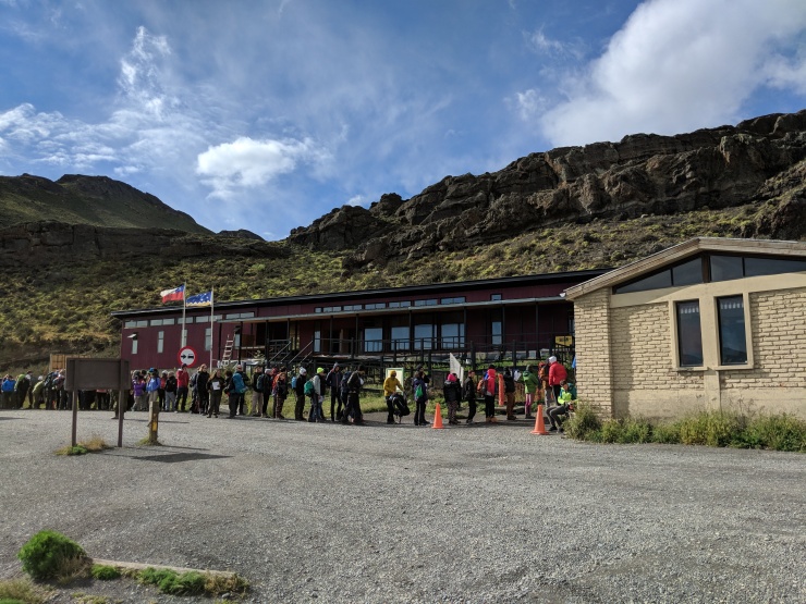 The line that quickly formed at the Laguna Amarga entrance to Torres del Paine National Park. Everyone is waiting to pay the park entrance fee and watch the safety video.